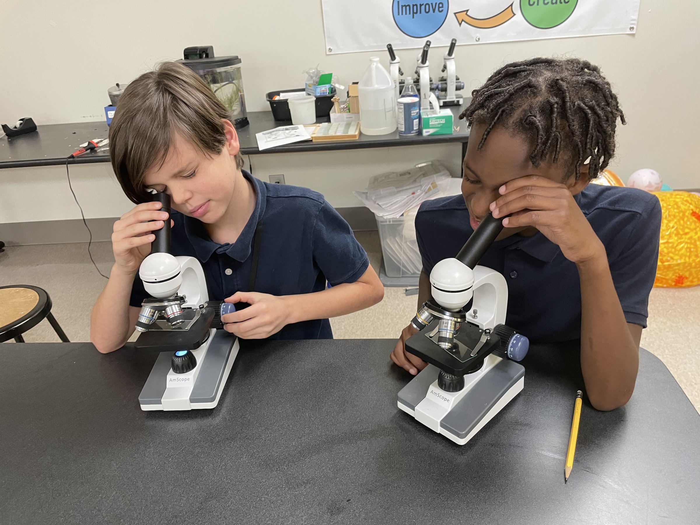 Westside students examining slides under microscopes in the science lab