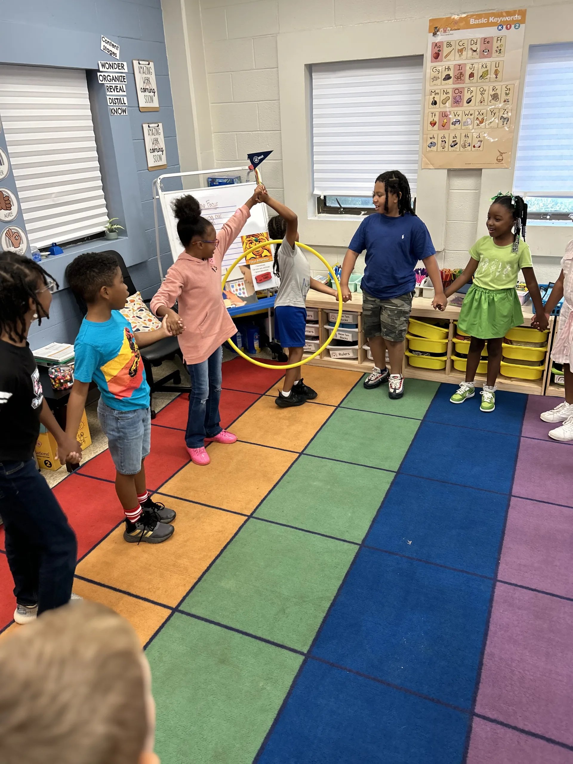Students holding hands in a circle during morning meeting