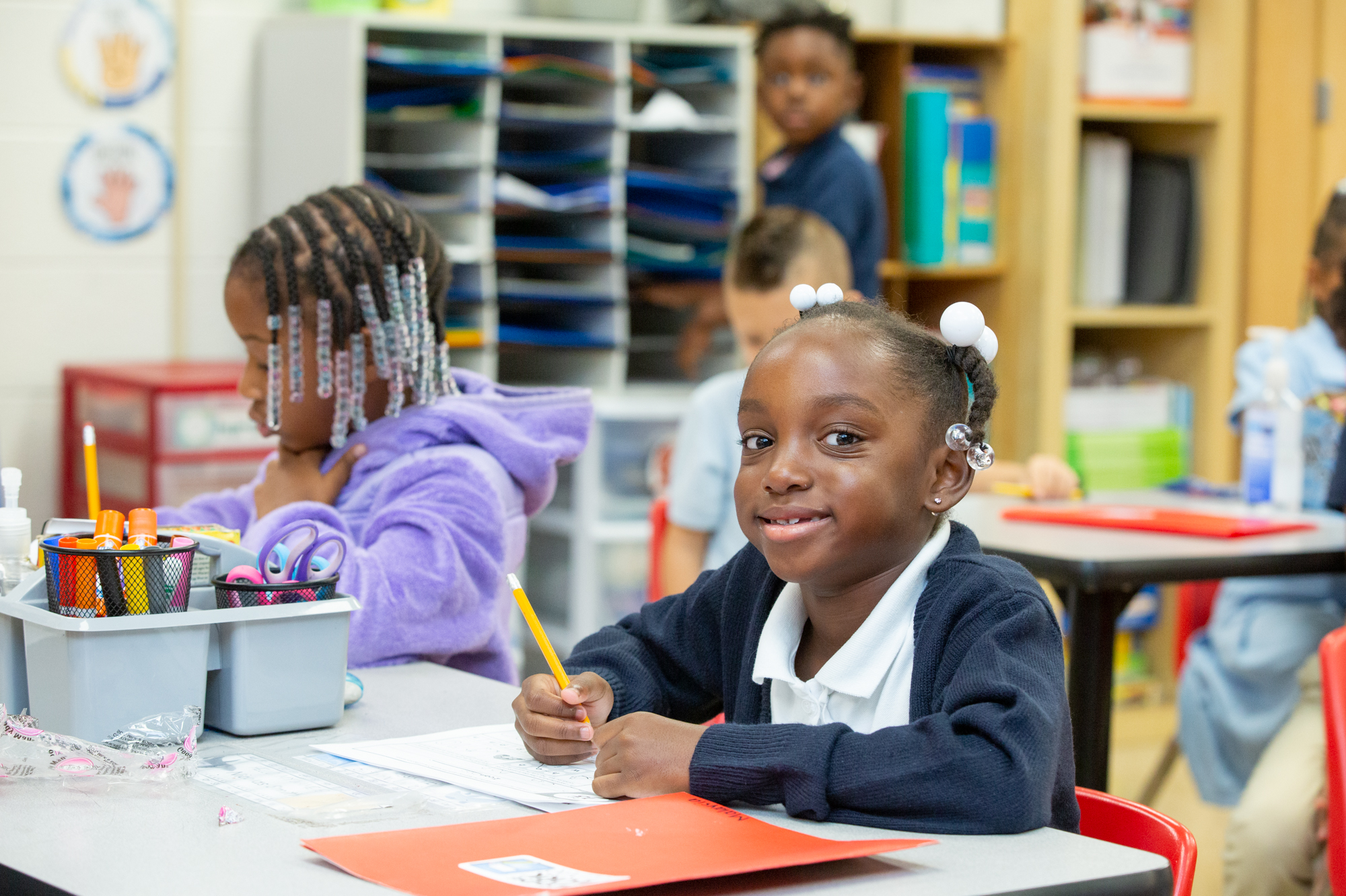 Elementary student smiling at her desk