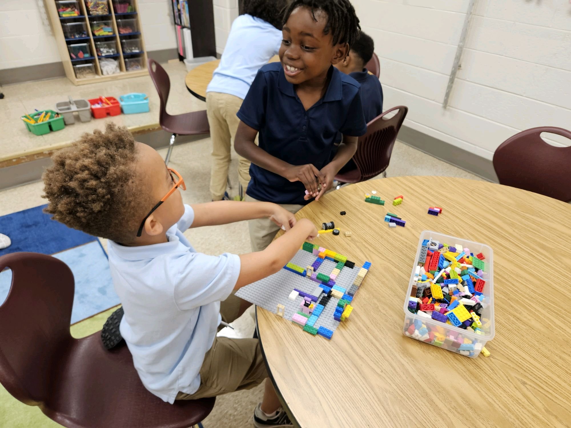 Student building with LEGO bricks